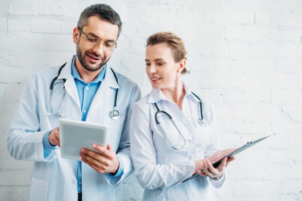 happy-doctors-working-together-with-tablet-and-clipboard.jpg